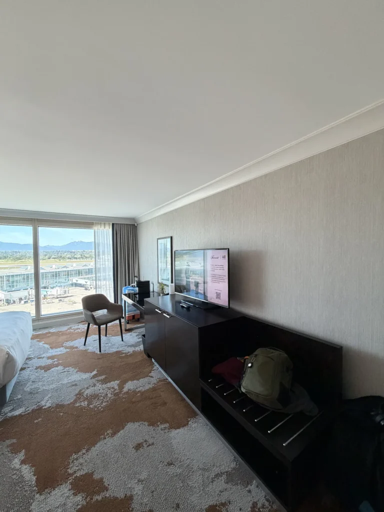 view of the entertainment center and minibar in the room of the Vancouver Fairmont airport hotel