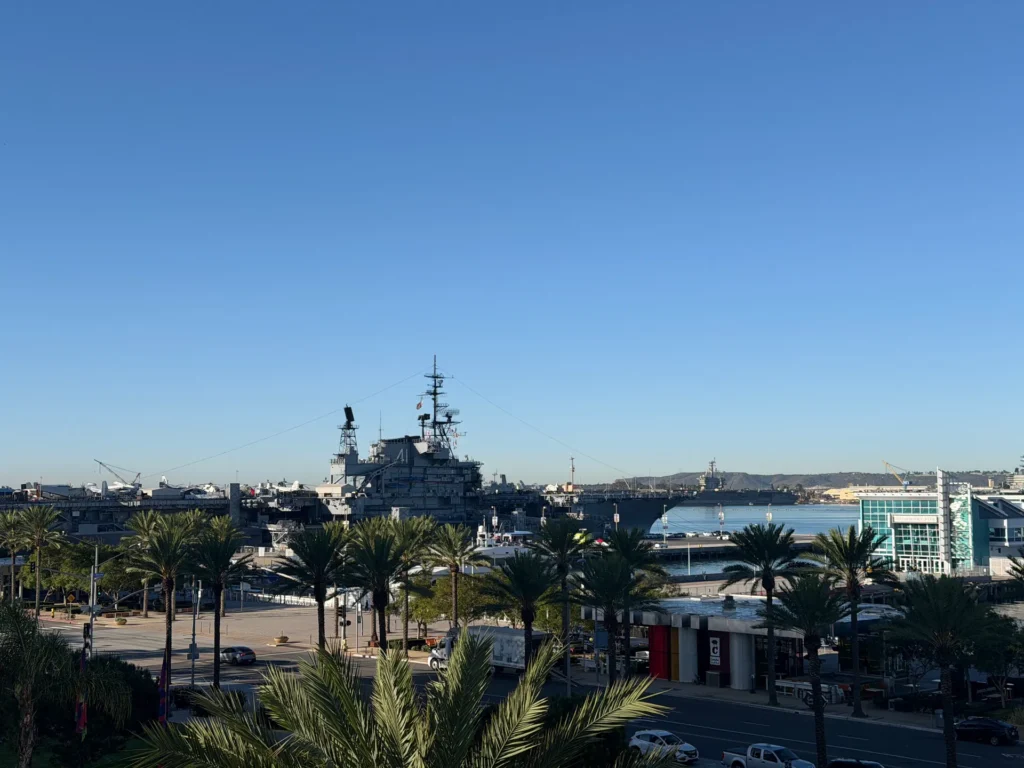 USS Midway Museum and Broadway Pier seen from SpringHill Suites San Diego, with an active Navy carrier across the bay
