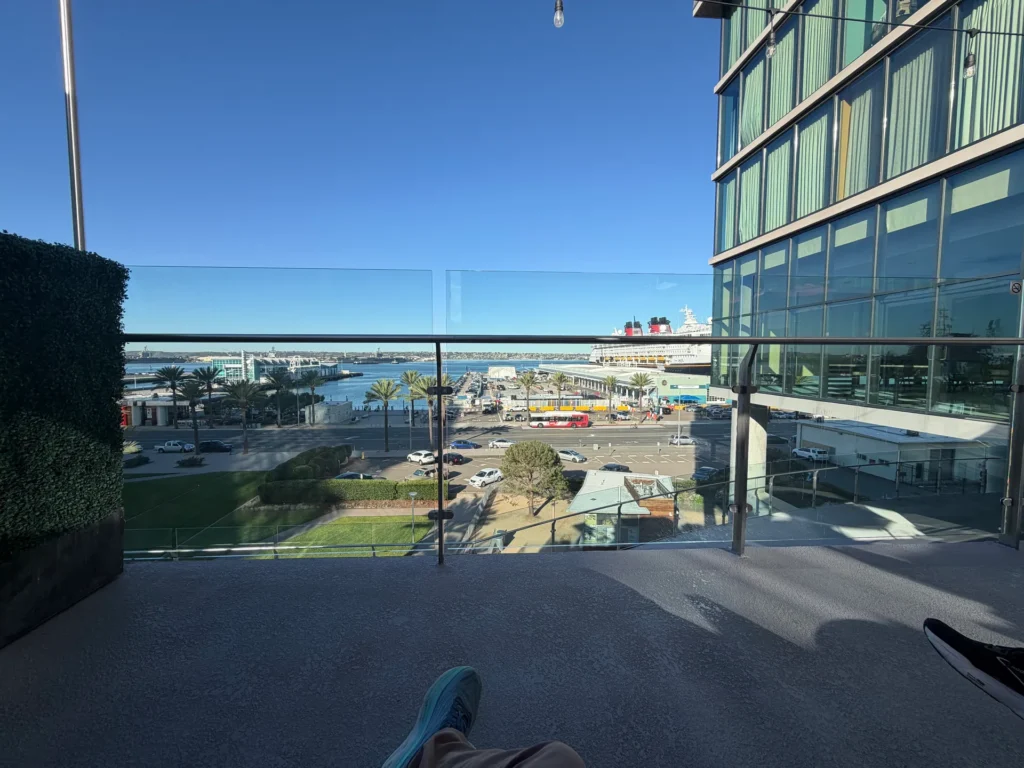 Relaxing on the 5th-floor patio at SpringHill Suites San Diego with the Disney Magic docked across Harbor Drive