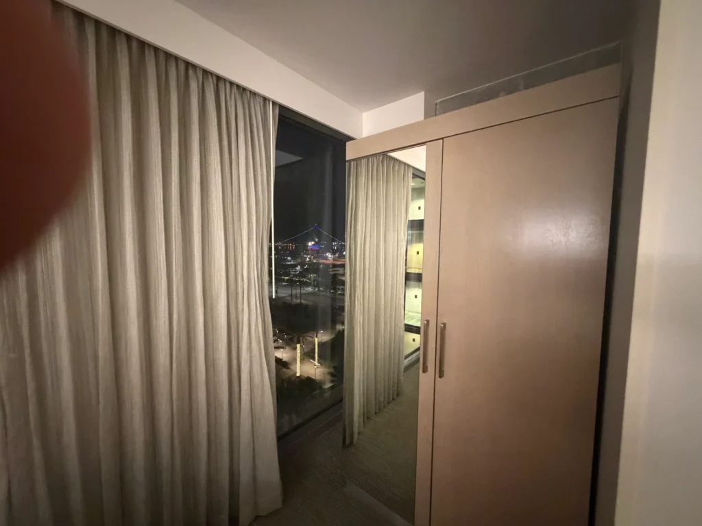 Window looking out at the harbor at night, beside the mirrored wardrobe